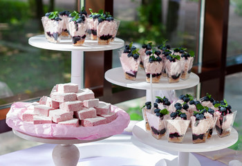 Cakes and marshmallows close up on a white stand