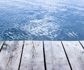 Blur abstract sea background and wooden table for montage with copy space. Summer vacation concept.