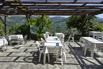 Tables of an outdoor restaurant in Aieta, a village in the mountains of the Calabria region.