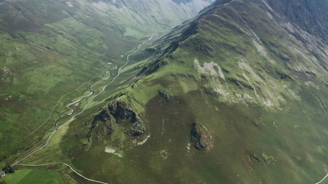 Aerial view of a road winding its way along a narrow mountain pass (Honister Pass, Lake District)