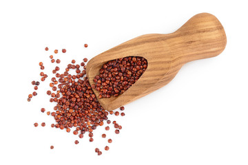 red quinoa seeds in wooden scoop isolated on white background with clipping path and full depth of field. Top view. Flat lay