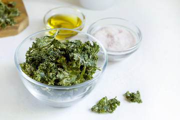 kale chips in glass bowl on white background