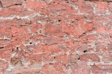 Old stone wall for the backdrop. The wall surface is covered with plaster and red paint.