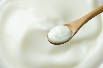 yogurt on spoon wooden  on yogurt background