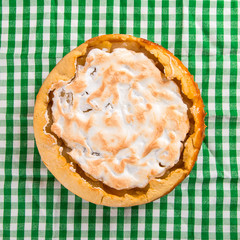 Pear pie with cream, homemade pastries on the table with a green napkin.
