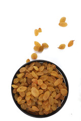 Bowl with dried golden raisins isolated on white. Dried Grapes.