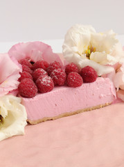 Raspberry cheesecake with berries and fresh flowers on pink plate food photo, sweet cake food photo art, kitchen, menu and restaurant photoshoot