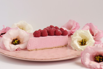 Raspberry cheesecake with berries and fresh flowers on pink plate food photo, sweet cake food photo art, kitchen, menu and restaurant photoshoot