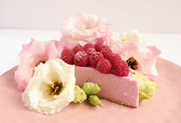Raspberry cheesecake with berries and fresh flowers on pink plate food photo, sweet cake food photo art, kitchen, menu and restaurant photoshoot