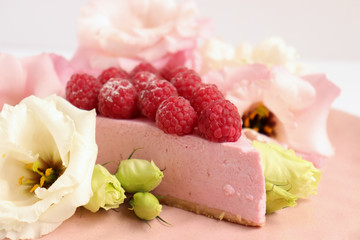 Raspberry cheesecake with berries and fresh flowers on pink plate food photo, sweet cake food photo art, kitchen, menu and restaurant photoshoot