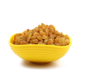 Bowl with dried golden raisins isolated on white. Dried Grapes.