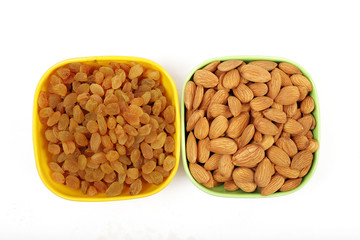 Bowl with dried golden raisins isolated on white. Dried Grapes.
