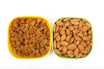 Bowl with dried golden raisins isolated on white. Dried Grapes.