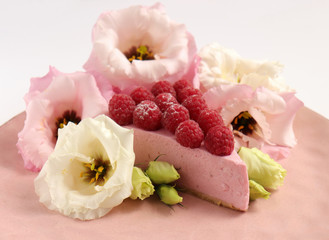 Raspberry cheesecake with berries and fresh flowers on pink plate food photo, sweet cake food photo art, kitchen, menu and restaurant photoshoot
