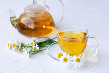 Herbal tea with chamomile in a glass jar. Healthy lifestyle. Proper nutrition. Vitamins and antioxidants.