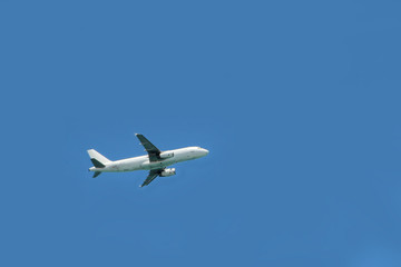 Fototapeta na wymiar Plane flying high in sky. View to air liner flying in blue sky