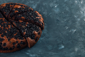 Blueberry pie with berries, homemade fresh pastries, on a stone background. Copy space.