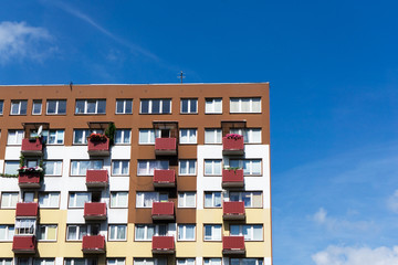 Bialystok city in Poland architecture background. High block of flats skyscraper living area. Old neighborhood retro style. Metal sheet elevation. Sunny balcony apartments.