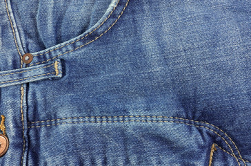 Blue denim trousers with fly and stitching. Close-up       