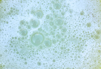 White foam background with soap bubbles, close-up, top view