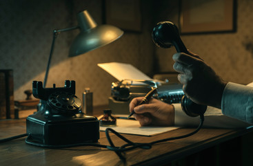 Film noir journalist working at office desk