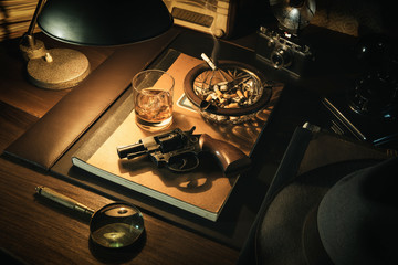 Film noir detective desktop with revolver - obrazy, fototapety, plakaty