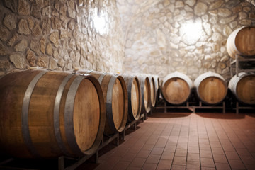 Barrels in cellar, wine making concept. Copy space.