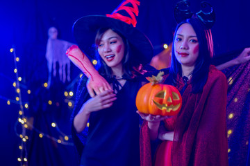 Asian women in witch costume in dark night forest scene. Halloween party concept.  party art design concept.