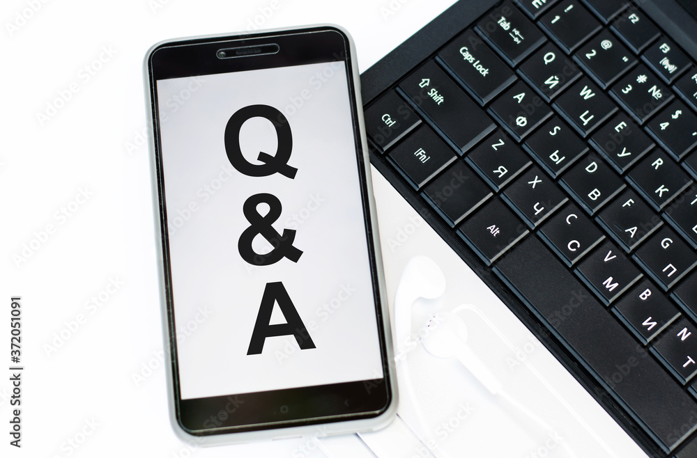 Poster q and a written phone that lies on the computer keyboard