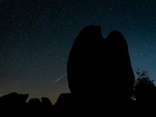Night landscape with Perseid meteor in Barruecos. Spain.