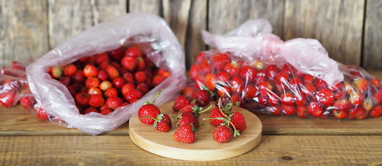 Packages with strawberries for storage in the freezer for future use.Food background with autumn strawberries.