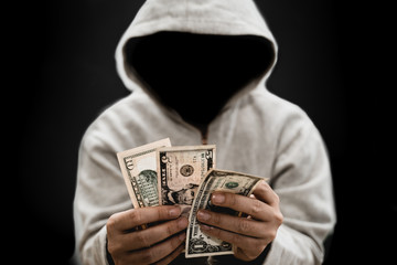 Hacker counting a moneys to stolen