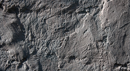 Grey textured plaster on an old wall. Background.