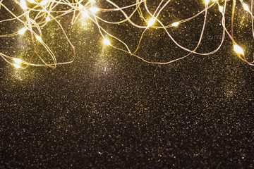 Beautiful shiny Christmas lights on glitter black background - Christmas and New Year celebration...