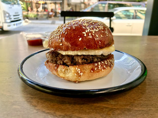 Sweet Hamburger with Brie Cheese and Honey at Fast Food Restaurant.