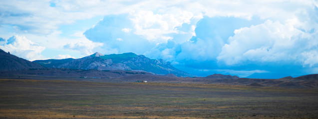  Landscape panorama. Mountains plain sky with clouds. Picturesque area. Copy copy for text.