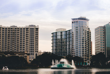 watching a fountain stroll through downtown Lake Eola on Orlando Florida on a fall winters afternoon on a weekend day. Lake Eola Park is located in the heart of Downtown Orlando, with a sidewalk  © Tamara Sales 