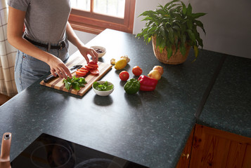 Woman preparing vegetarian dinner in a kitchen