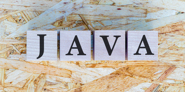 The inscription JAVA on wooden blocks on wooden background. Letter text on wooden cube. Programming language code script concept.