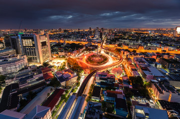 Fototapeta premium Cityscape of Victory Monument with car traffic on roundabout road in the morning at Bangkok