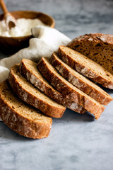 Loaf of sliced sourdough bread on a dark background, Close-up. Handmade Whole Grain Dark Bread