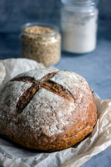 Loaf of homemade buckwheat bread on a dark background close-up copy space
