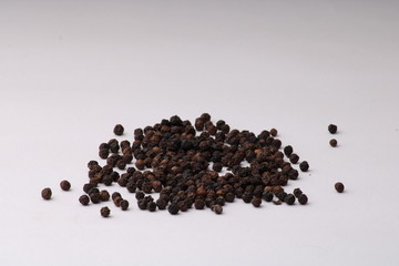 Close-up image of black pepper on white background
