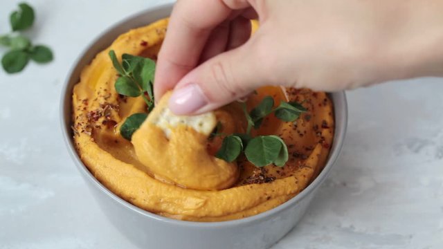 Sweet potato hummus or pumpkin dip in a gray bowl.