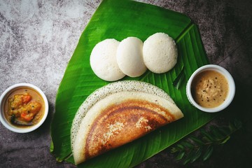 South Indian breakfast Idli Dosa sambar and chutney served in banana leaf