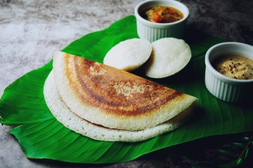 South Indian breakfast Idli Dosa sambar and chutney served in banana leaf