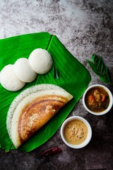 South Indian breakfast Idli Dosa sambar and chutney served in banana leaf