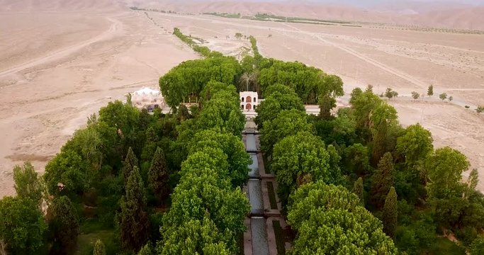A Green Persian Garden with trees and water stream in the middle of Desert in Kerman Iran