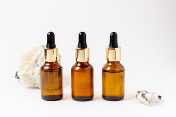 Amber Bottle for essential oils and cosmetic products. Glass bottle on white background. A dropper, a bottle with a sprayer