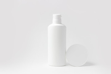 Set of white cosmetic bottles and jars on white background with place to add text